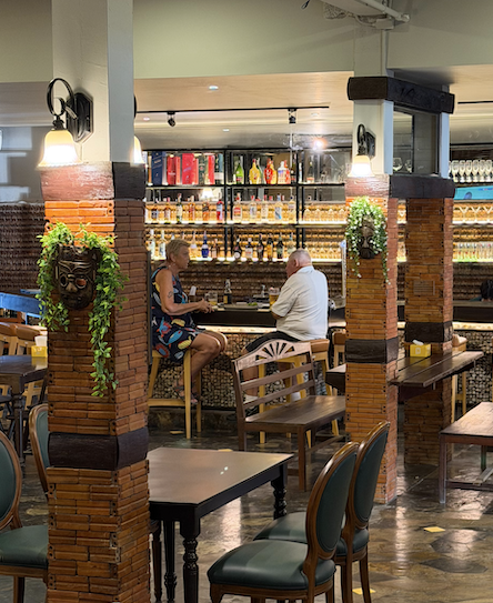 Guests at the bar at Green Tree, surrounded by brick columns